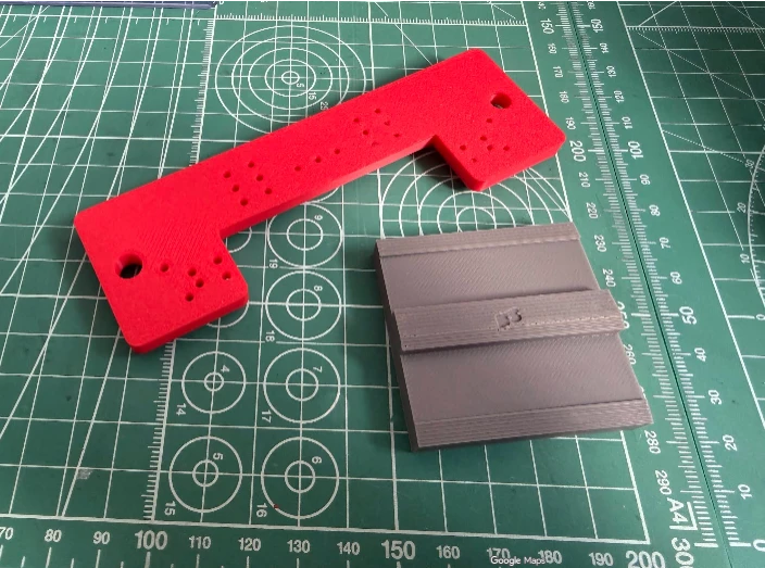 Model-building jigs we 3D printed in red and grey PLA+